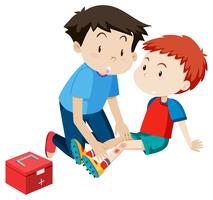 A man helping a boy first aid