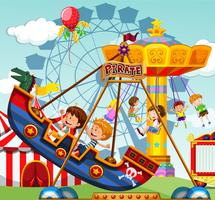 Children riding on rides at the funfair vector