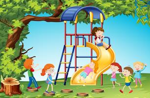 Children playing slide in playground vector