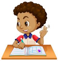 Young boy studying at desk vector