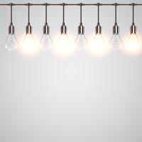 Realistic lightbulbs hanging and working, vector
