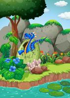 Blue dragon hatching egg by the river vector