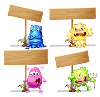 Monsters holding wooden signs