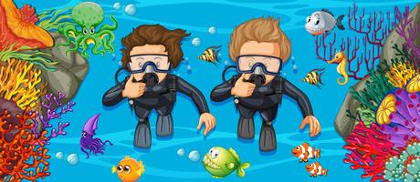 Scuba divers in the deep blue sea vector