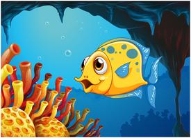 Un gran pez amarillo bajo el mar dentro de la cueva del mar. vector