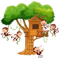 Monos jugando en la casa del árbol vector