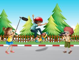 Children shooting vdo with boy skateboarding vector