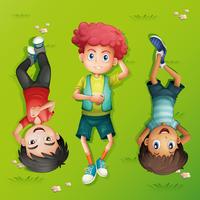 Three kids lying on the lawn vector