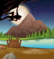 Man climbing rock on fullmoon night vector