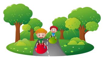 Two boys playing on big ball on the road vector