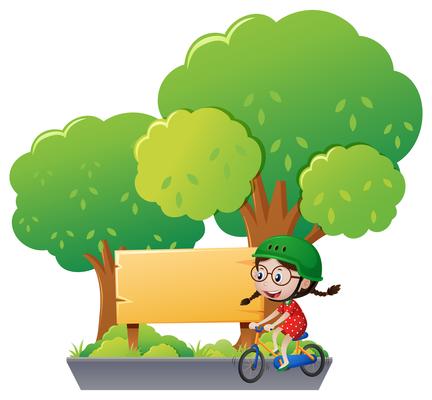 Wooden sign and girl riding bike in park