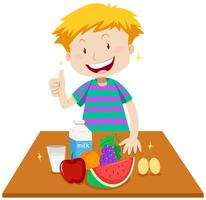 Little boy and healthy food on table vector