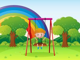 Little boy playing on the swing in the park vector