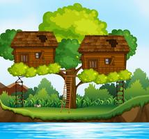 Dos casas en los árboles en el árbol por el río vector