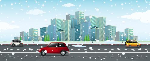 City scene with snow falling on the road vector