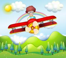A boy riding in a red plane