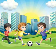 Children playing soccer in the park vector