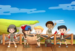 Kids in safari outfit reading map vector