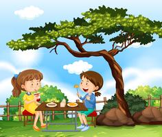 Dos chicas haciendo picnic en el parque vector