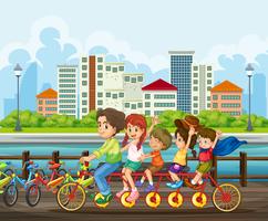 Una familia montando bicicleta tandem en el parque vector
