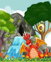 Dragón junto a la cascada y cueva. vector