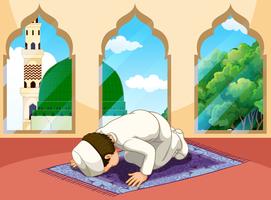 Un hombre musulmán reza en la mezquita. vector