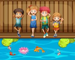 Cuatro niños divirtiéndose junto al estanque de peces. vector