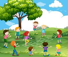 Happy children playing hopscotch in park vector