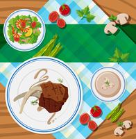 Table scene with steaks and salad vector