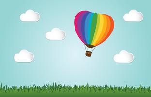 Origami made colorful hot air balloon fly over grass.paper art style. vector