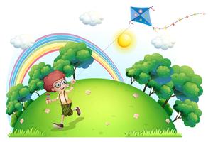 A boy playing with his kite at the hilltop vector