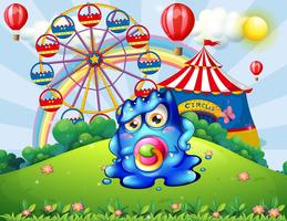 A baby monster at the hilltop with a carnival vector