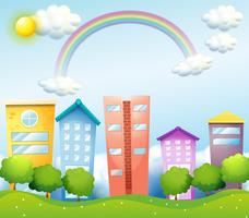 A rainbow above the tall buildings vector