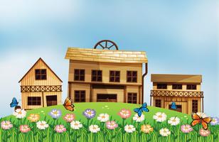 Three different wooden houses at the hill vector