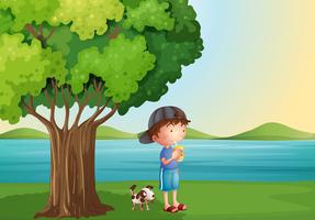 Un niño y su mascota debajo del árbol. vector