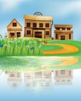 A pond with a reflection of the wooden houses vector