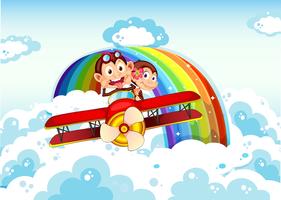 Playful monkeys riding on a plane near the rainbow vector