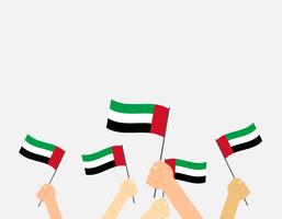 Manos de ilustración vectorial sosteniendo banderas de Emiratos Árabes Unidos sobre fondo blanco vector