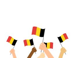 Manos de ilustración vectorial sosteniendo banderas de Bélgica sobre fondo blanco vector