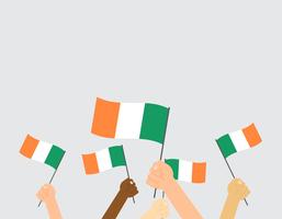 Vector illustration of hands holding Ireland flags isolated on grey background
