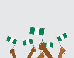 Manos de ilustración vectorial sosteniendo banderas de Nigeria aisladas sobre fondo vector