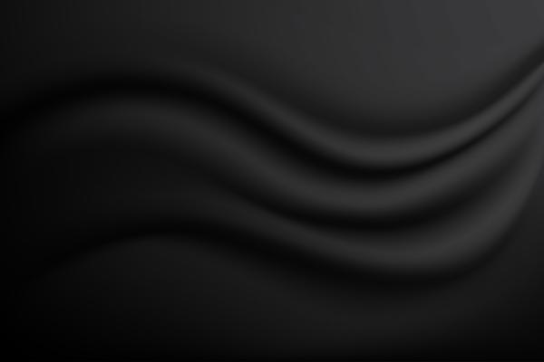 A background texture of soft rippled black fabric textile material