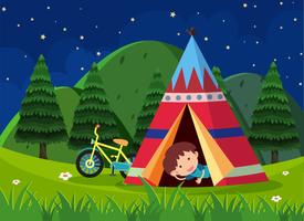 Boy camping out in the park vector