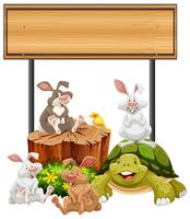 Letrero de madera con conejos y tortuga. vector