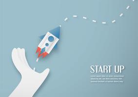 Vector illustration with start up concept in paper cut, craft and origami style. Rocket is flying on blue sky. Template design for web banner, poster, cover, advertisement. 3D art craft for kids.