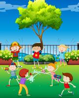 Children playing water gun in the park vector