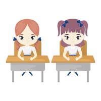 little student girls seated in school desks