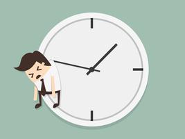 Businessman hangs on hand of clock vector