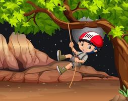 Boy climbing a tree at night vector