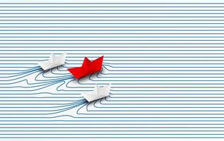 Red paper boat leading white paper boats through water to goal
